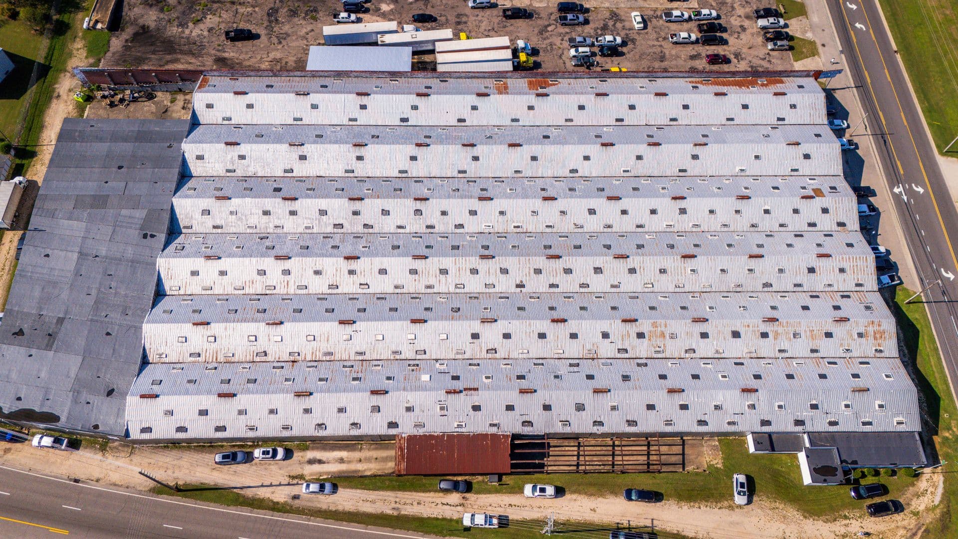 Aerial view of large commercial building with flat roof