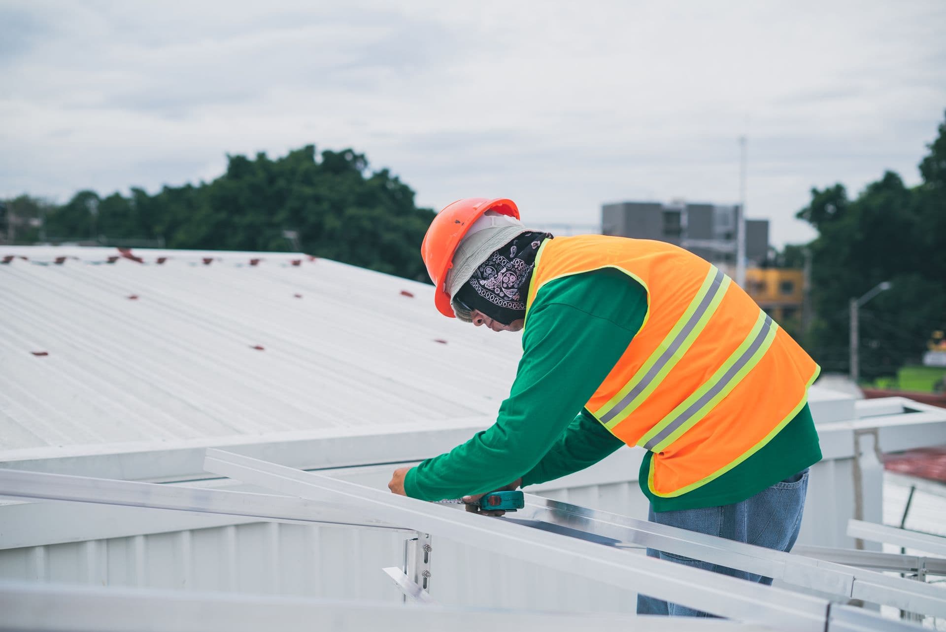 Professional roofer installing flat roof system