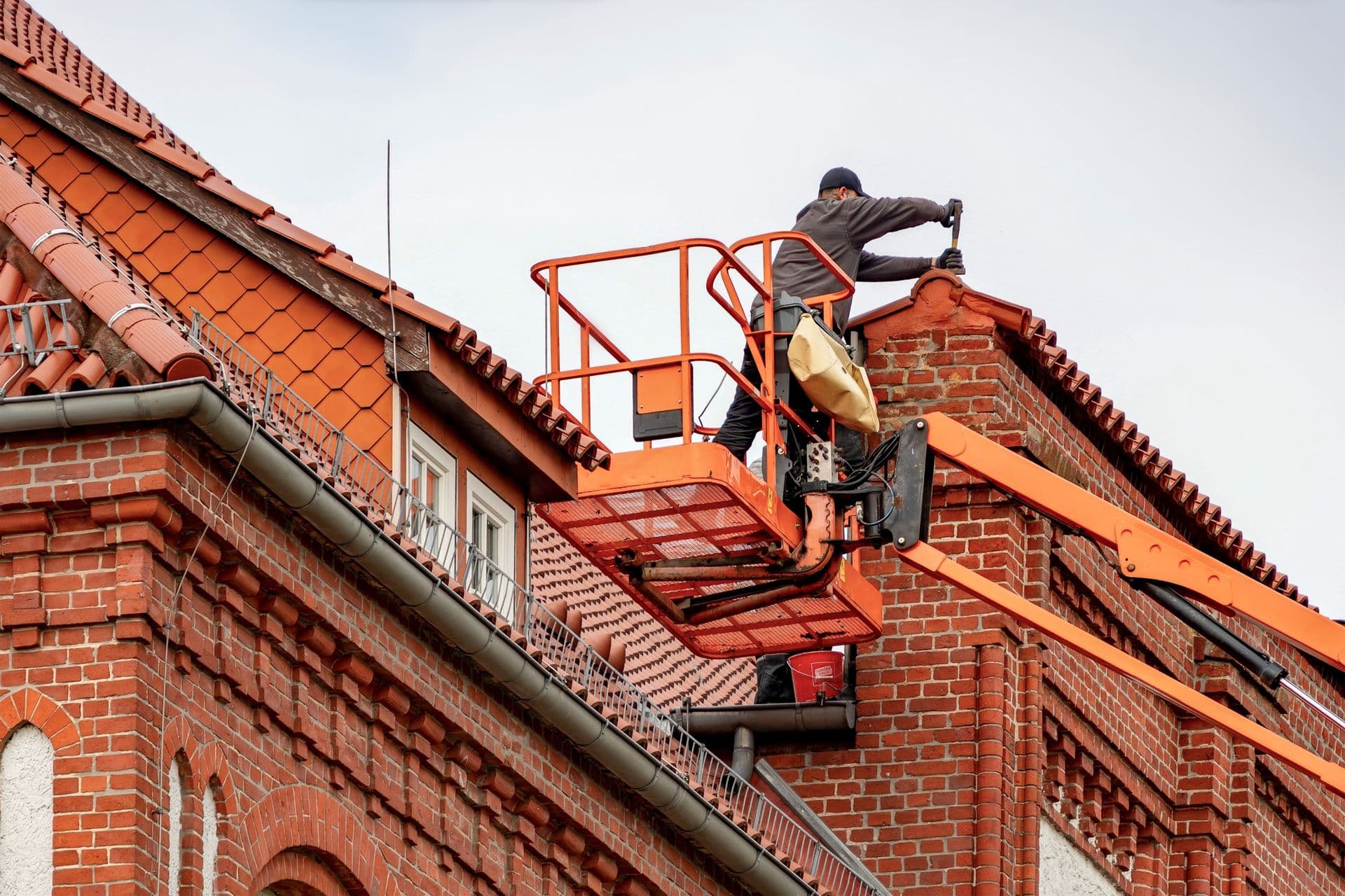 Roofer conducting flat roof maintenance inspection