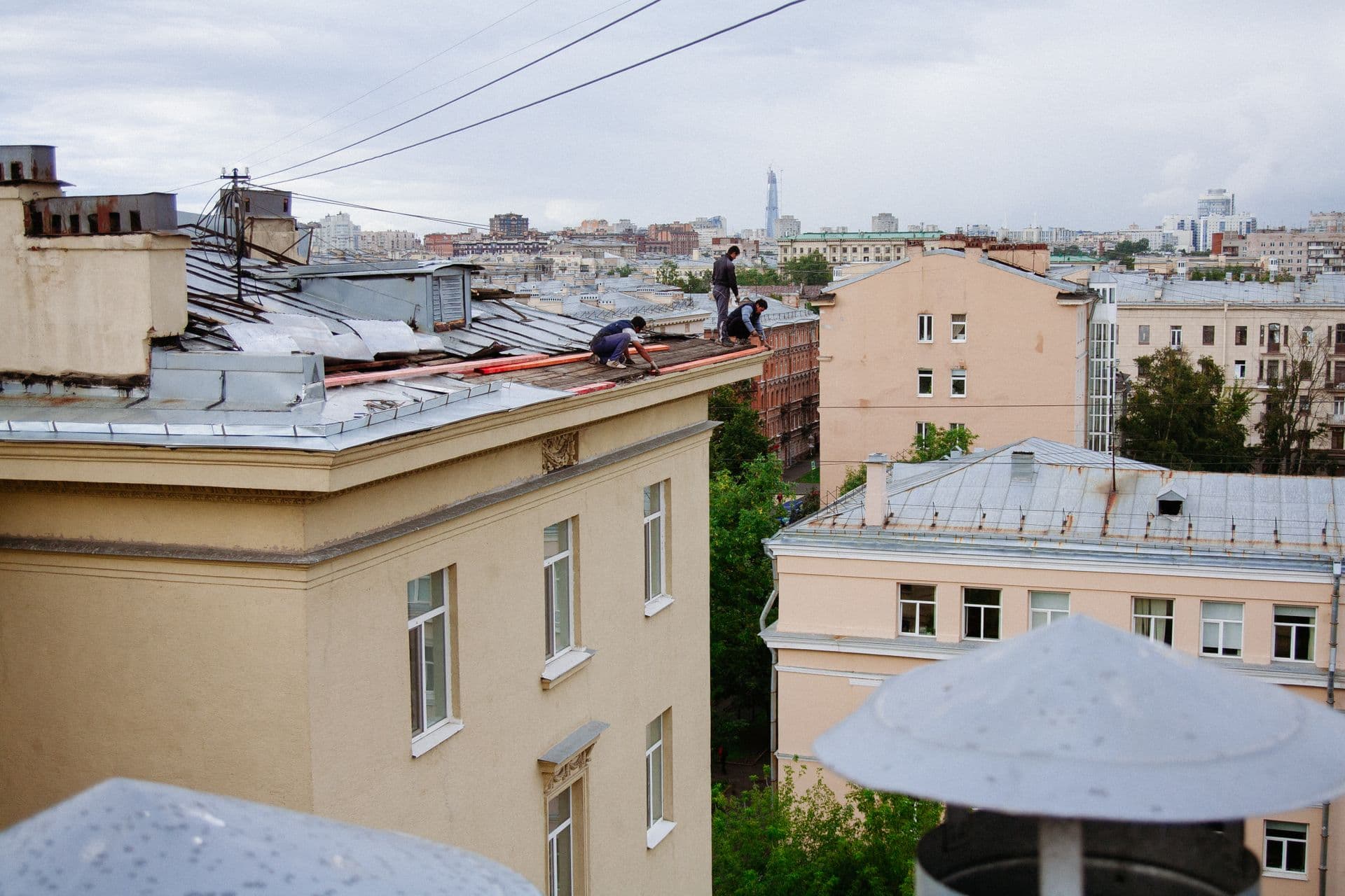 Roofers carrying out flat roof repairs